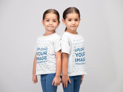 Mockup Twin Girls Wearing T-Shirts Standing Against Each Other's Back