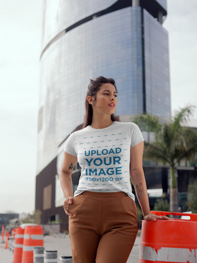 Round Neck Tee Mockup of a Girl Near a Big Modern Building 22681