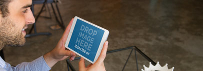 Tablet Mockup of a Bearded Man Using an iPad Mini