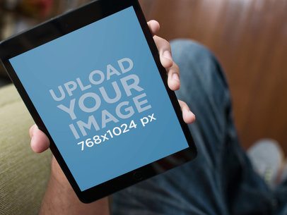 Mockup of a Black iPad Mini Featuring a Man's Hand