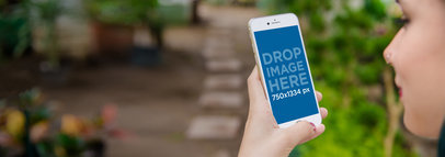 iPhone 6 Mockup Featuring a Woman at a Greenhouse a3856