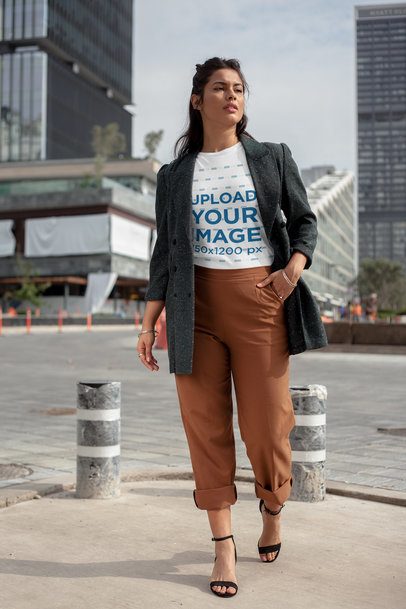 Round Neck Tee Mockup of a Woman Walking by a Financial Center