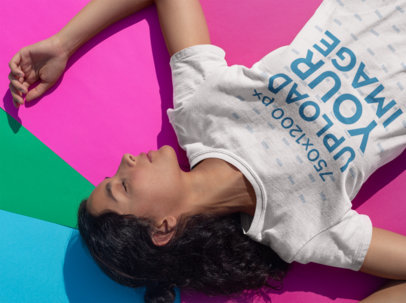 Tshirt Mockup of a Woman Resting Over Colorful Pasteboards
