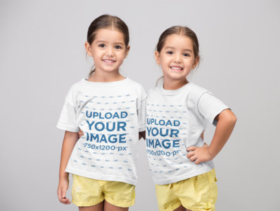 Round Neck T-Shirt Mockup of Twin Girls at a Photo Studio