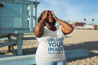 Plus Size T-Shirt Mockup of a Woman Holding Her Hands to Her Face on the Beach 18289