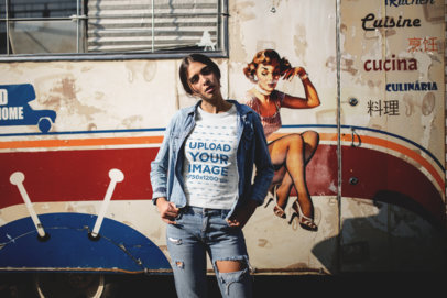 Mockup of a Girl Wearing a T-Shirt and a Denim Jacket Against an Old Food Truck 19387