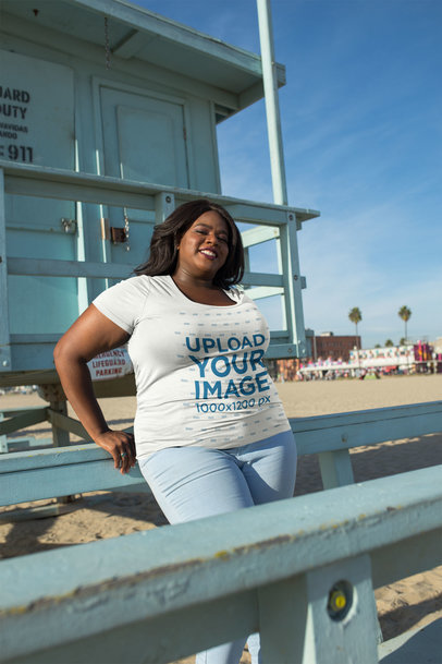Mockup of a Woman Wearing a Plus Size T-Shirt Leaning on a Lifeguard Tower 18290