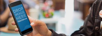 Mockup of a Young Man Using iPhone 6 at a Local Coffee Shop a3939
