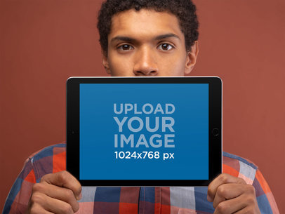 Landscape Position Space Gray iPad Mockup Featuring a Man Against a Brown Background 22632
