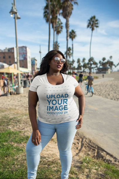 Mockup of a Woman Wearing a Plus Size T-Shirt by the Beach