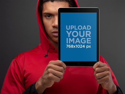 Mockup of an iPad Held up by a Man Wearing a Red Hoodie 22635