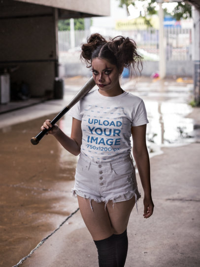 Round Neck Tee Mockup Featuring a Woman with Halloween Clown Makeup and a Baseball Bat