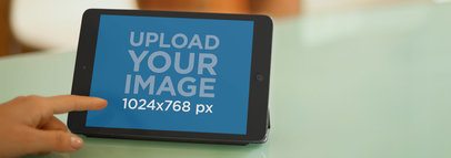 Mockup of a Black iPad Mini on Top of a Glass Table 