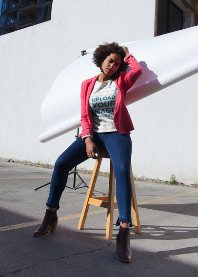 Round Neck T-Shirt Mockup Featuring a Woman with Curly Hair in an Urban Photo Shoot