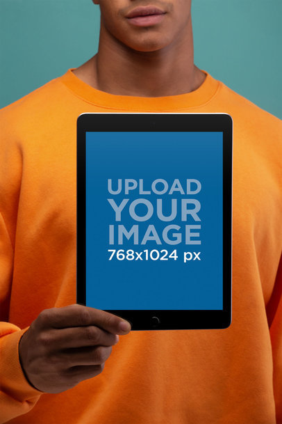 Mockup of an iPad Being Held Against a Man's Chest