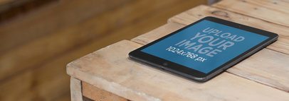 Mockup of a Black iPad Mini at a Wood Workshop