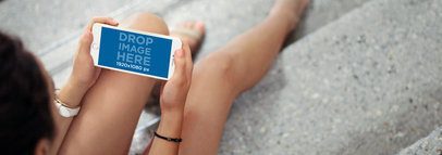 iPhone 6 Plus Mockup of a Young Lady Sitting Down