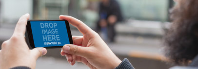 Mockup of a Man Taking a Photograph With An Android Phone