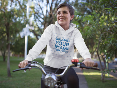 Hoodie Mockup of a Woman Riding a Bike at a Park