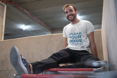 Mockup of a Man Wearing a Tshirt Sitting on a Shopping Cart