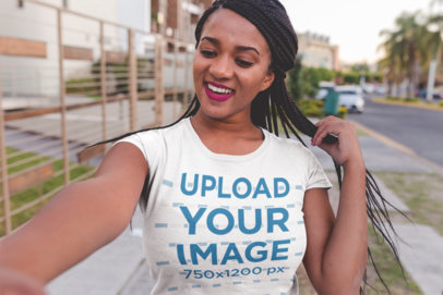 Selfie T-Shirt Mockup of a Woman with Braids Walking Down the Street