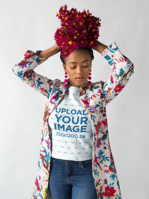 Mockup of a Woman Wearing a T-Shirt Holding Flowers Over Her Head