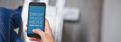 iPhone 6 Mockup of a Woman Sitting Cross-Legged at the Office