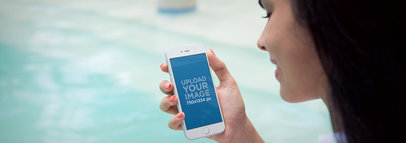 iPhone 6 Mockup of a Woman Holding an iPhone by the Pool