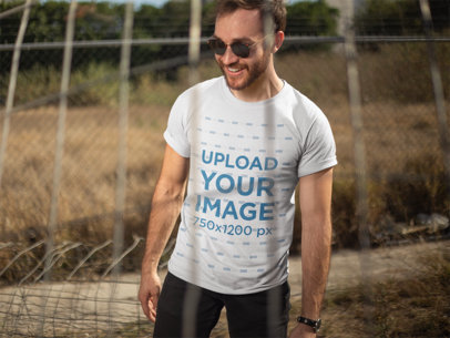 Mockup of a Man Wearing a Camping T-Shirt on a Dry Sunny Day