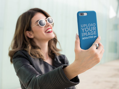 Phone Case Mockup Featuring a Woman Taking a Selfie and Smiling