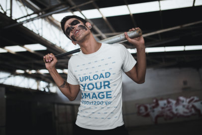 Tshirt Mockup Featuring a Man with Skull Makeup and a Baseball Bat Against his Back