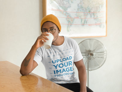 Mockup of a Man Wearing a T-Shirt and Beanie Drinking Coffee