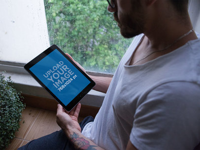 iPad Mockup Featuring a Man by a Rainy Window 22829