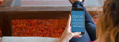 iPhone 6 Mockup Template of a Young Lady Relaxing at Home