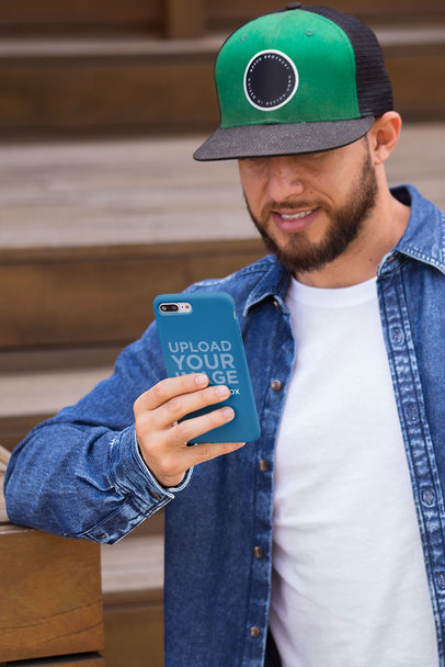 Phone Case Mockup Held by a Man with a Black and Green Hat 22875