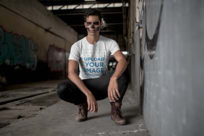 T-Shirt Mockup of a Man Kneeling with Halloween Makeup