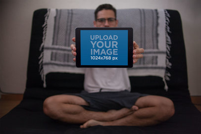 Mockup of a Man Holding Up an iPad