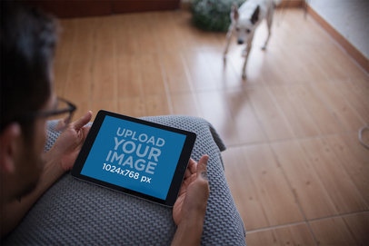 Landscape iPad Mockup Featuring a Man in His Living Room 22836