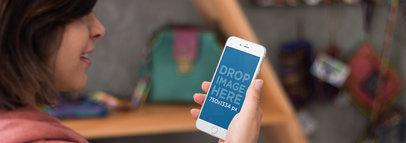 iPhone 6 Mockup Featuring a Woman Using an iPhone at a Local Boutique a3031wide