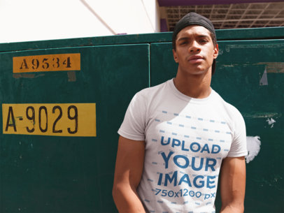 T-Shirt Mockup of a Man Leaning Against a Street Electric Container 22411