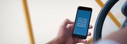 Mockup of a iPhone 6 of a Man Using iPhone 6 While Driving