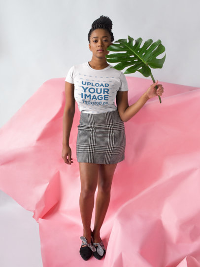 Mockup of a Woman Wearing a T-shirt and Checkered Skirt in a Studio