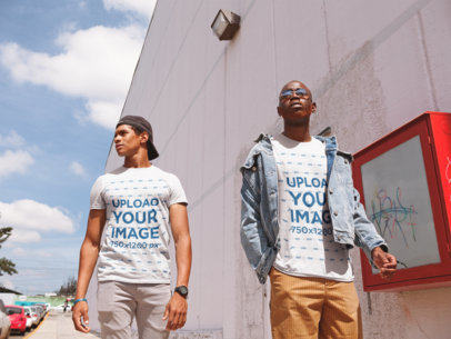 T-Shirt Mockup of Two Friends Walking Outside a Shopping Center