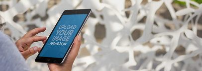 Tablet Mockup of a Black iPad Mini at a Museum