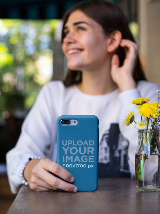 Mockup of a Smiling Woman Holding a Phone Case