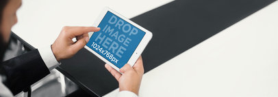 Mockup of an Executive Man Using an iPad Mini at a Conference Room a4050