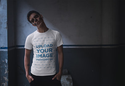 T-Shirt Mockup of a Man with Skull Makeup Against a Wasted Wall