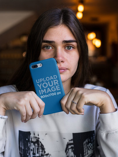 Mockup of a Woman with Blue Eyes Holding a Phone Case 22887
