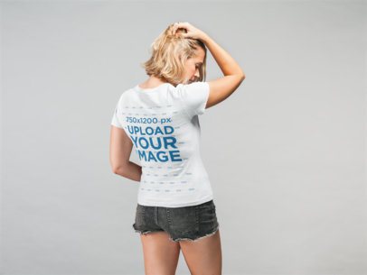 Mockup of a Woman Wearing a T-Shirt and Denim Shorts While Touching Her Hair