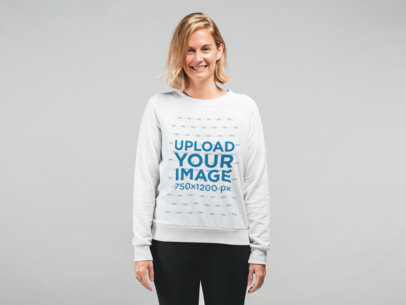 Sweatshirt Mockup Featuring a Blonde Woman Smiling in a Studio